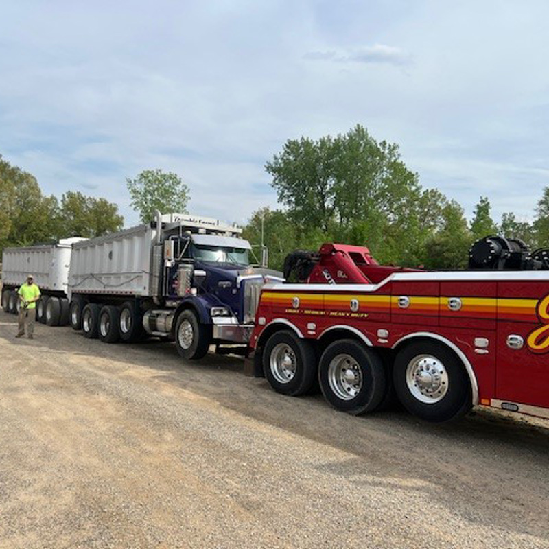 heavy duty towing truck towing a semi truck