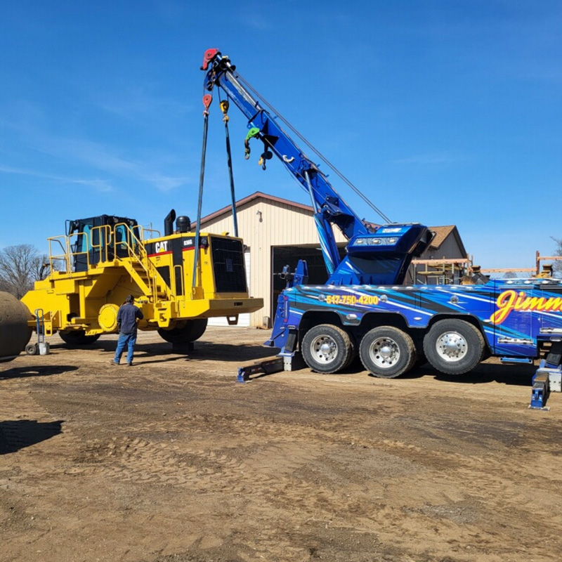 tow truck hauling a heavy equipment